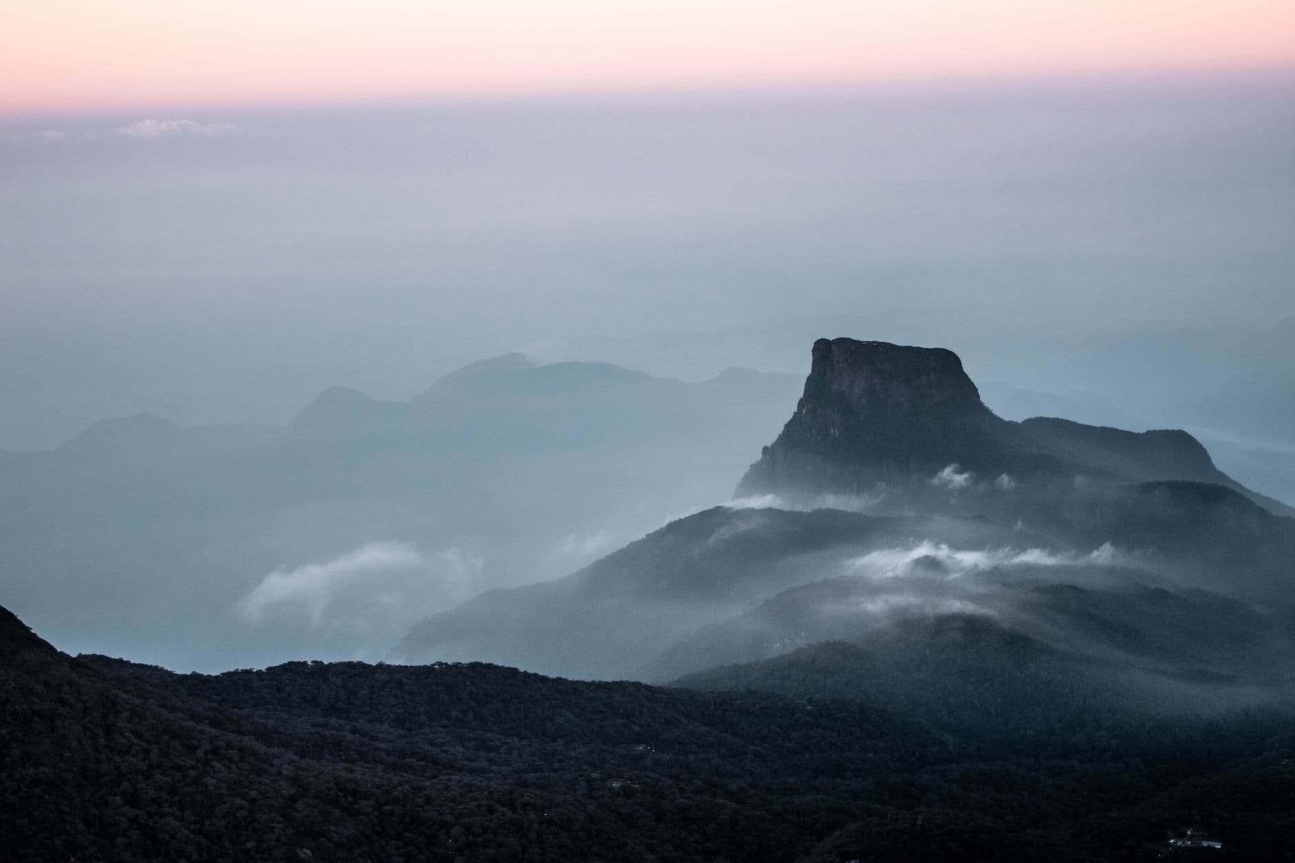 Adam's Peak rising above the dawn cloud line