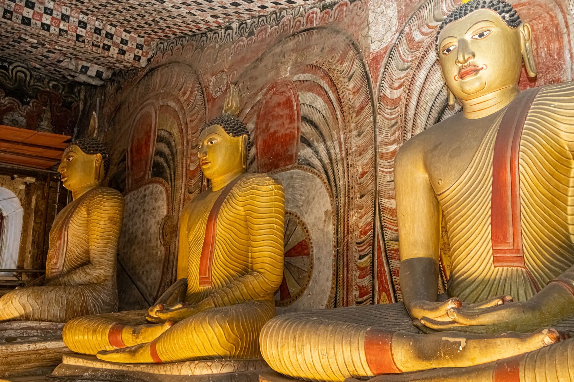 Rows of seated Buddhas inside the Dambulla caves