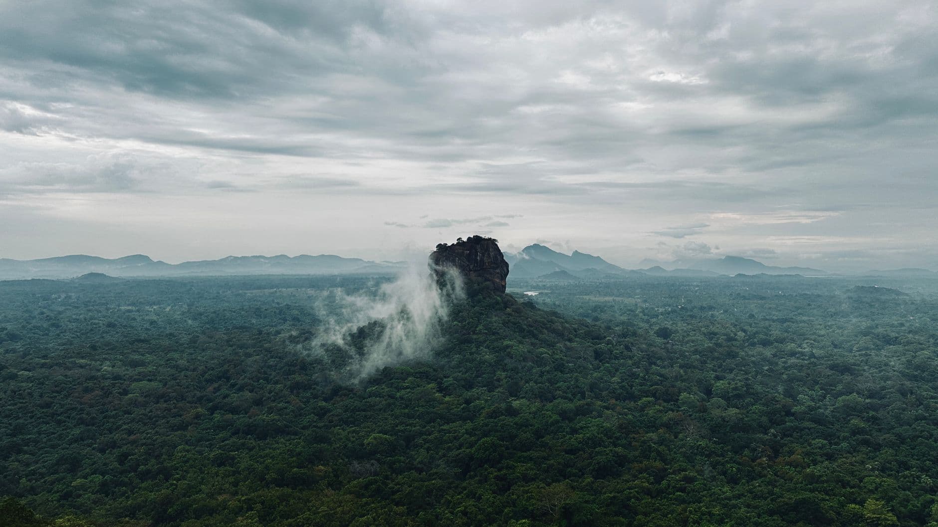 The Cultural Triangle plains from above, Sigiriya rising through the mist