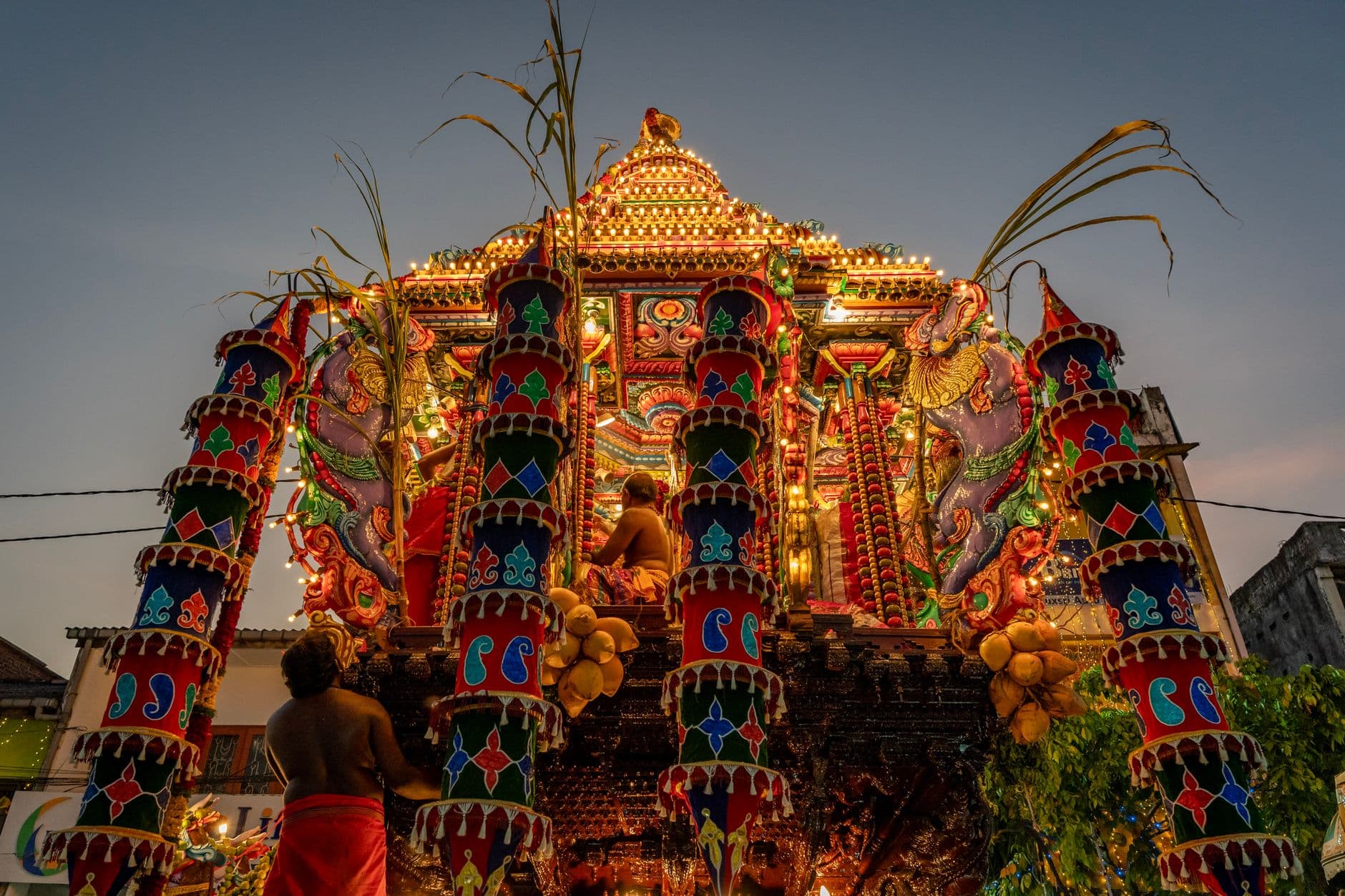 A chariot procession lit up for a Hindu temple festival at night
