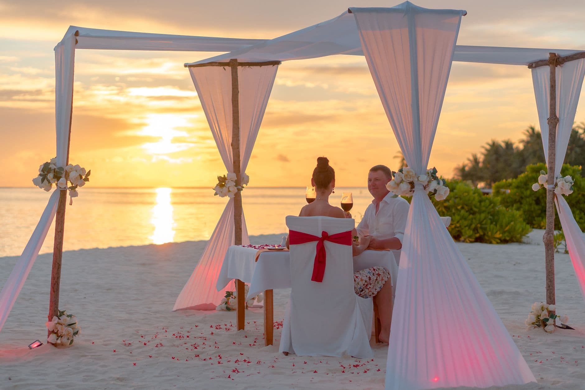 Honeymoon couple on a quiet Sri Lankan beach at sunset