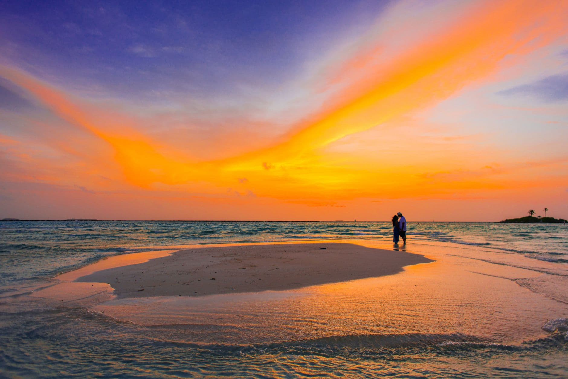 Couple watching the sunset from a Sri Lankan beach