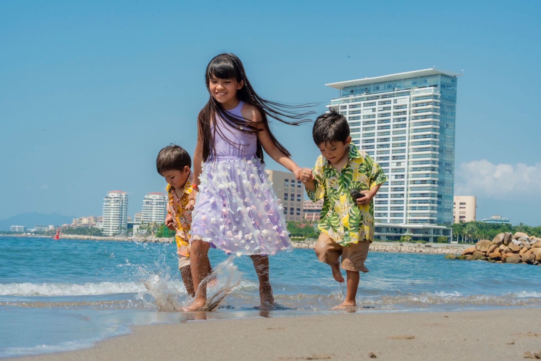 Children playing in calm Sri Lankan beach shallows